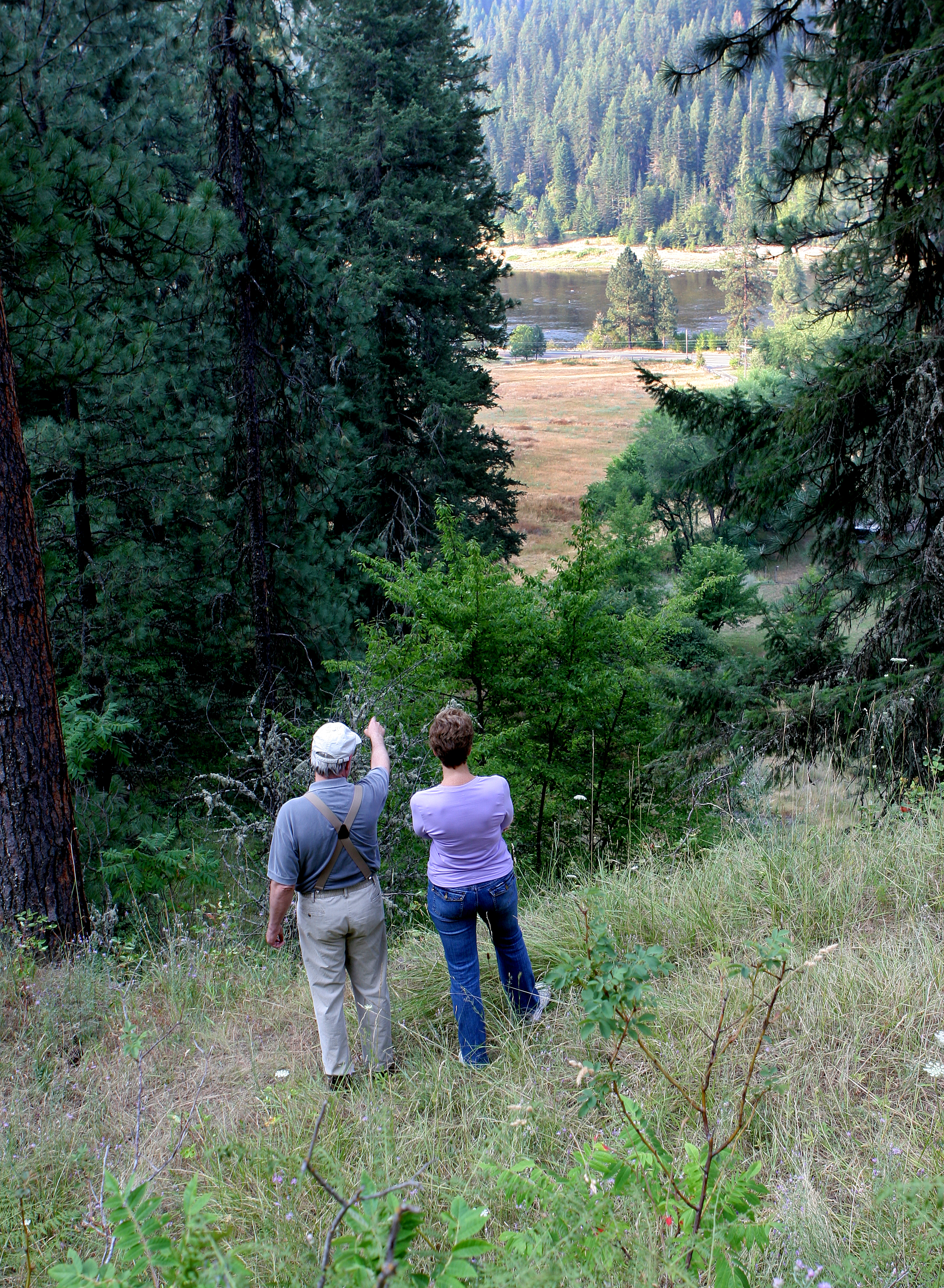 man-pointing-at-river-while-woman-looks.jpg